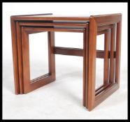 A retro 1970's teak wood nest of tables in the Danish manner. The tables of square form with