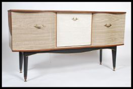 A retro 1970's melamine two one sideboard dresser being raised on tapering legs with drawers and