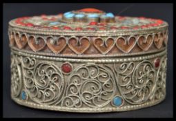 A vintage 20th century white metal / silver gilt and Turquoise trinket pot / box of circular form,