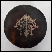 An early 20th century tortoiseshell and silver inlay box of circular form having silver hallmarked