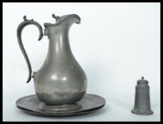 A group of 19th century Georgian pewter wares to include a water jug a pair of circular plates and a