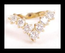 A hallmarked 18ct gold and diamond wishbone ring. The seven round cut diamonds of approx 10pnts each