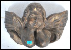 A 20th century papier mache decorative wall handing ornament in the form of a winged cherub angel