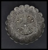 A 19th century Indian / Islamic Silver filigree dish having a scrolled central medallion with