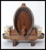 An early 20th century spirit decanter dispense in the form of a novelty spirit coopered barrel