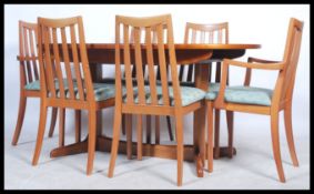 G-Plan - A 20th century teak wood dining room suite comprising of an oval dining table with a fold