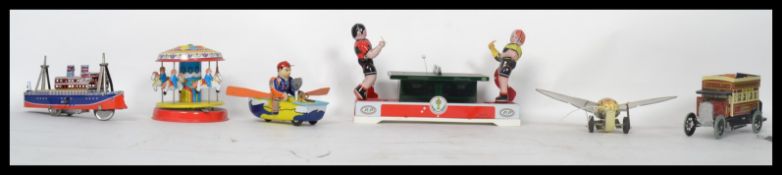A collection of vintage style clockwork tin plate toys to include ping pong table tennis, vintage