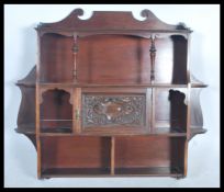 A  Victorian mahogany hanging wall cabinet. The shelves of multiple sections with gallery back
