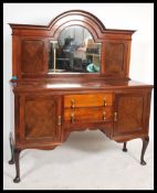 A 1930's mahogany mirror back sideboard having an arrangement of drawers and cupboards being