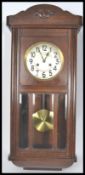 An early 20th century oak cased wall clock. The silvered dial having faceted hands with carved
