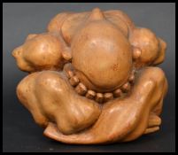 An early 20th century Oriental hardwood carved Wee