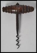 A 19th century corkscrew bottle opener having a tu