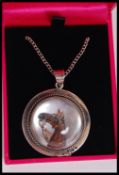 A silver Essex crystal necklace pendant depicting