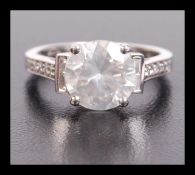 An 18ct white gold diamond ring, the central brill