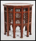 A Moroccan wooden occasional wine table having twe