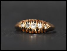 A hallmarked 18ct gold and diamond ring having 5 o