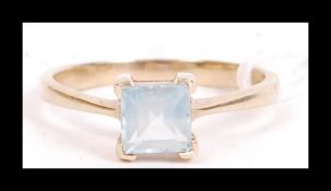 A hallmarked 9ct gold ring set with a square cut p