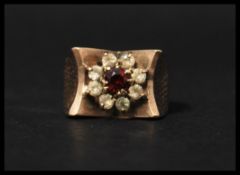 A hallmarked 9ct gold garnet and white stone clust