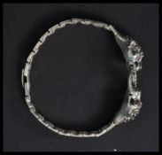 A sterling silver bracelet in the form of two pant