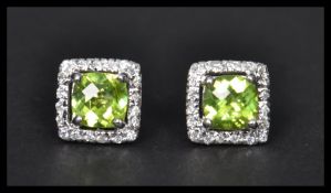 A pair of sterling silver and CZ stud earrings of
