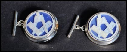 A pair of sterling silver an enamel cuff links set with masonic symbols. Weighs 9 grams.