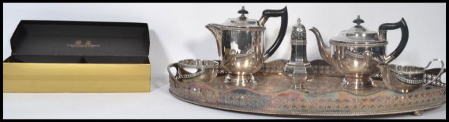 A 20th century silver plated tea service together with a gallery silver platted tray, sugar shaker