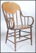 A Victorian bentwood panel back office desk chair - armchair being raised on turned legs with