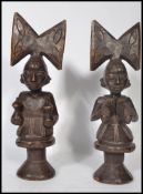 A pair of early 20th century Congo standing fertility figurines of a man and a woman raised on a