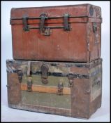 Two vintage early 20th century steamer trunks to include a canvas and wooden bound military trunk