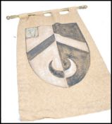 A 20th century fabric scroll printed with a  coat of arms together with a pair of spelter 18th