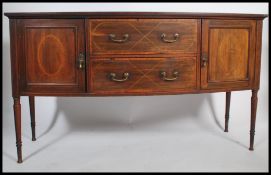 An Edwardian mahogany inlaid bow fronted sideboard by Maple & Co. Raised on squared tapering legs