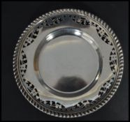 A Canadian sterling silver pin dish tray of circular form having a gadrooned edge with pierced