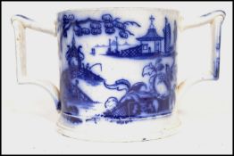 A 19th century Chinese blue and white hand painted porcelain twin handled loving cup having shaped