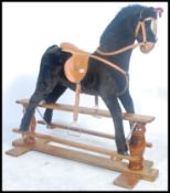 A good quality Mamas and Papas child's rocking horse on wooden base with ribbon award for the pony