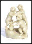 A Chinese unusual carved one piece soapstone jade coloured diorama carving of three monkeys on