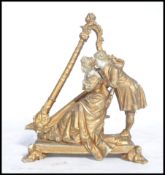 A 19th century parian ware gilded figure group of a courting lady and gent next to a harp. Raised on