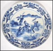 An early 19th century Chinese blue and white cabinet plate depicting fighting warriors and