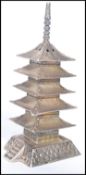 A Chinese silver pepperpot pepperette in the form of a Pagoda building. Stamped 925. Weighs 30.5