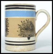 A 19th century Mocha ware tankard having a white g