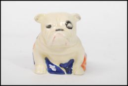 A Royal Doulton figurine depicting a Winston Churchill British bulldog drapped in the Union flag