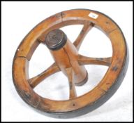 A large vintage 20th century wooden and cast metal pulley wheel.