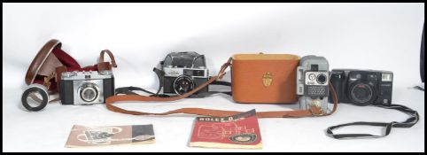 A collection of vintage cameras to include a Zeiss Ikon Contina, a vintage Eumig Servomatic and an