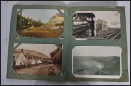 Postcards; an album of assorted early postcards - largely street scenes, with some being local