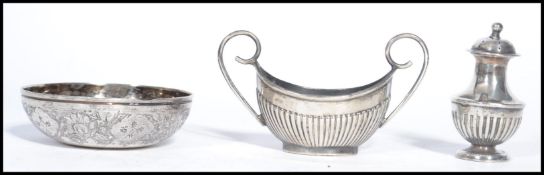 Two silver hallmarked condiments along with an Islamic silver bowl. Please see images. Total
