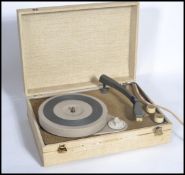 A vintage retro 20th century electric record player. The portable record deck housed within a