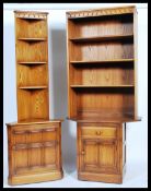 Ercol - Mural -  An unusual elm upright cupboard having a wide top and bookcase above with angled