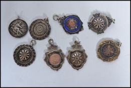 A group of eight silver hallmarked fob medals one being on an albert chain. Fobs to include darts