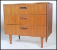 A vintage retro 20th century Danish inspire teak chest of drawers. The bank of drawers having
