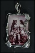 A large sterling silver panel necklace pendant having an inset erotic scene of two ladies. Weighs 24