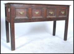 An 18th century Jacobean oak moulded front dresser base of small proportions. Raised on squared legs